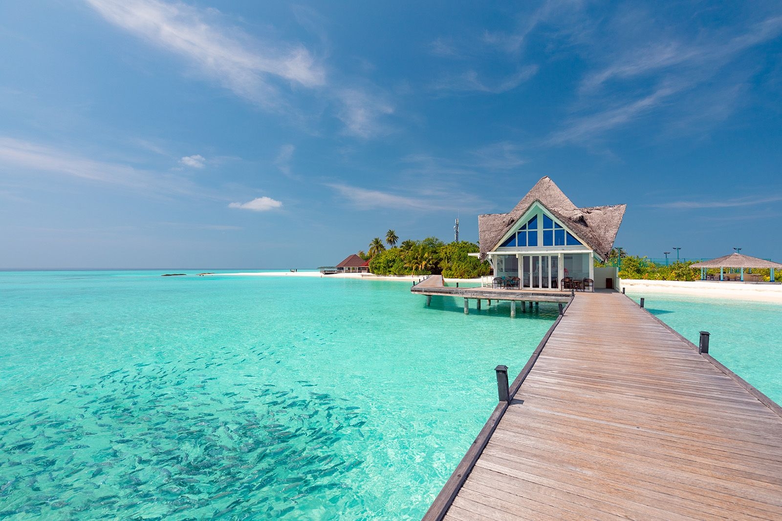Luxury tropical resort and overwater villa in turquoise water